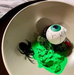 halloween-ice-cream-treats-spooky-ice-scream-recipes-for-the-occasion-image-4-bowl-of-green-bubblegum-ice-cream-with-eyeball-and-spiders-frosted-fusions