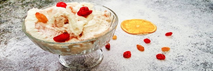 Homemade-Cranberry-Orange-Ice-Cream-Recipe-featured-image-207x620w-glass-dessert-dish-with-cranberry-and-orange-ice-cream-with-slices-of-orange-and-scattered-cranberries-to-the-side-frosted-fusions