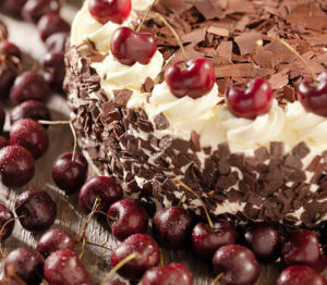 black-forest-ice-cream-cake-image-1-black-forest-gateau-with-fresh-cherries-scattered-frosted-fusions