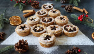 20-festive-winter-ice-cream-recipe-ideas-image-1-several-mince-pies-displayed-in-a-christmas-tree-pattern-with-christmas-decorations-frosted-fusion