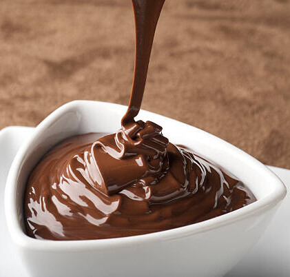 Homemade Chocolate Brownie Ice Cream Recipe image 4 fudge sauce being poured into white dish frosted fusions