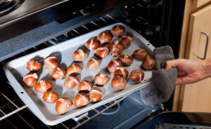 homemade-roasted-chestnut-ice-cream-recipe-image-6-baking-tray-of-chestnuts-being-put-into-oven-frosted-fusions
