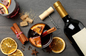 mulled-wine-homemade-ice-cream-recipe-image-3-ingredients-used-for-mulled-wine-ice-cream-bottle-of-wine-cinnamon-sticks-cloves-orange-slices-corkscrew-and-glass-of-mulled-wine-frosted-fusions