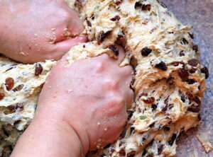stollen-cake-ice-cream-recipe-a-taste-of-germany-image-2-stollen-cake-mixture-with-raisins-and-mixed-fruits-being-kneaded-frosted-fusions