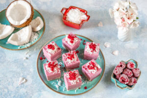 Dairy-Free-Coconut-Based-Frozen-Treats-–-Creamy-Dreamy-100-Delicious-image-3-coconut-mixed-berries-froyo-bites-garnished-with-coconut-shavings-and-fresh-berries-frosted-fusions