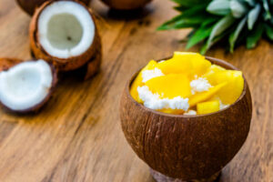 Dairy-Free-Coconut-Based-Frozen-Treats-–-Creamy-Dreamy-100-Delicious-image-5-fresh-mango-with-coconut-ice-cream-served-in-coconut-shell-frosted-fusion