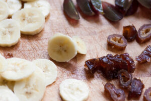 Homemade-Low-Fat-Date-And-Banana-Vegan-Ice-Cream-Recipe-image-1-sliced-bananas-and-dates-white-background-Frosted-Fusions