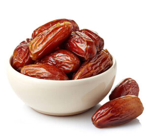 Homemade-Low-Fat-Date-And-Banana-Vegan-Ice-Cream-Recipe-image-2-small-bowl-filled-with-fresh-dates-white-background-Frosted-Fusions
