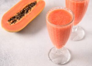 Homemade-Tropical-Papaya-Ice-Cream-Sorbet-Froyo-Recipes-To-Beat-The-Winter-Blues-image-4-rall-glass-with-papaya-froyo-with-fresh-papaya-to-the-side-frosted-fusions