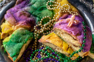 5-Creole-Cajun-Inspired-Ice-Cream-Recipes-To-Jazz-Up-Your-Mardi-Gras-image-8-mardi-gras-colours-on-a-king-cake-with-tiny-child-figurine-Frosted-fusions 5-Creole-Cajun-Inspired-Ice-Cream-Recipes-To-Jazz-Up-Your-Mardi-Gras-image-8-mardi-gras-colours-on-a-king-cake-with-tiny-child-figurine-Frosted-fusions