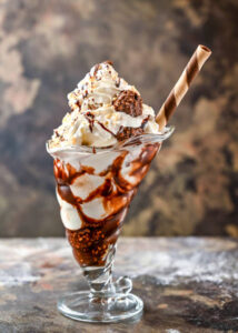 Ferrero-Rocher-Lovers-This-Homemade-Ice-Cream-Recipe-Is-For-You-Image-5-sundae-glass-filled-with-ferrero-rocher-ce-cream-topped-with-ferrero-rochers-Frosted-Fusions