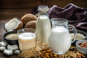 Homemade-Dairy-Free-Almond-Milk-Ice-Cream-Recipe-image-2-selection-of-nut-milks-in-glass-and-bottle-including-almond-and-coconut-Frosted-Fusions