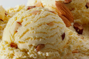 Homemade-Diary-Free-Almond-Milk-Ice-Cream-Recipe-image-5-close-up-of-scoop-of-delicious-looking-ice-cream-with-chopped-almonds-Frosted-Fusions