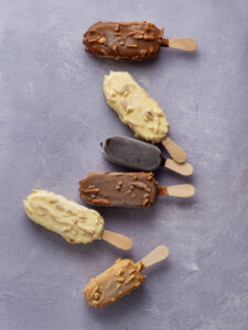 Homemade-Magnums-Create-The-Latest-Trending-Flavours-At-Home-image-6-selection-of-magnum-ice-cream-bars-on-granite-surface-top-view-Frosted-Fusions