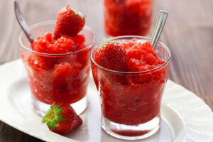 Homemade-Strawberry-Sorbet-Recipe-image-3-two-glasses-of-strawberry-sorbet-topped-with-fresh-sliced-strawberries-Frosted-Fusions