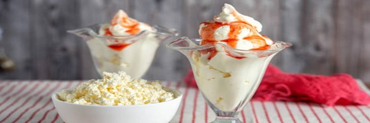 Is-Viral-Cottage-Cheese-Ice-Cream-Worth-All-The-Hype-featured-image-207x620w-Strawberry-ice-cream-in-dessert-glasses-with-a-bowl-of-cottage-cheese-Frosted-Fusions