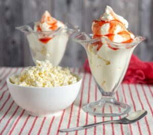 Is-Viral-Cottage-Cheese-Ice-Cream-Worth-All-The-Hype-image-3-atrawberry-ice-cream-in-glasses-with-a-bowl-of-cottage-cheese-Frosted-Fusions
