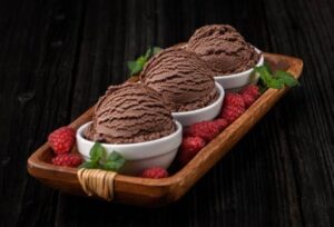Love-At-First-Scoop-–-Valentines-Ice-Cream-Recipe-Ideas-image-1-dish-with-chocolate-ice-cream-and-fresh-raspberries-with-mint-sprig-Frosted-Fusions
