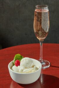 Love-At-First-Scoop-–-Valentines-Ice-Cream-Recipe-Ideas-image-6-glass-of-pink-champagne-with-bowl-of-ice-cream-and-a-red-berry-on-top-Frosted-Fusions