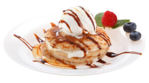 Holy-Crepe-Homemade-Pancake-Ice-Cream-image-8-plate-with-pancakes-and-scoop-of-ice-cream-with-chocolate-sauce-drizzled-and-fresh-strawberries-Frosted-Fusions
