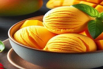 Homemade-Mango-Chilli-Sorbet-–-Naturally-Vegan-Dairy-Free-featured-image-637x1920w-bowl-of-mango-sorbet-with-fresh-mango-and-fresh-red-chillis-to-the-side-Frosted-Fusions