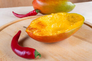 Homemade-Mango-Chilli-Sorbet-Naturally-Vegan-Dairy-Free-image 1 mango shell filled with sorbet and fresh chiilis to the side Frosted-Fusions