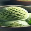 Homemade Matcha Ice Cream Recipe – A Taste Of Japan featured image 637x1920w bowl of matcha ice cream with matcha powder in bowls in background and green tea leaves Forsted Fusions