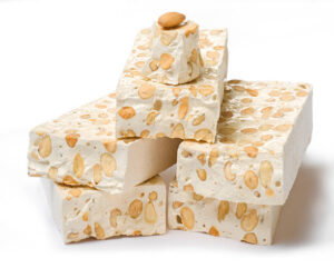 Homemade Nougat Ice Cream – A Classic British Treat Reimagined image 2 pieces of nougat with nuts white background Frosted Fusions