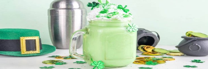 Mint-To-Be-Shamrock-Shake-Ice-Cream-Recipes-For-St.-Patricks-Day-featured-image-207x620w-shamrock-shake-in-glass-with-shamrocks-gold-coins-and-traditional-Irish-Green-hat-Frosted-Fusions
