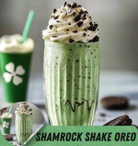 Mint-To-Be-Shamrock-Shake-Ice-Cream-Recipes-For-St.-Patricks-Day-image-1-shamrock-shake-in-tall-glass-with-cup-in-background-with-shamrock-on-it-Frosted-Fusions