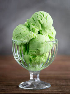 Mint-To-Be-Shamrock-Shake-Ice-Cream-Recipes-For-St.-Patricks-Day-image-8-dessert-glass-dish-with-scoops-of-mint-ice-cream-Frosted-Fusions