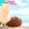 Piña Colada Sorbet & Ice Cream – The Best Of Both Worlds Featured image 207x620w pina colada in tall glass with umbrellas with beach setting in the background Frosted Fusions