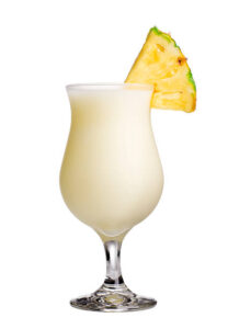 Pina-Colada-Sorbet-Ice-Cream-–-The-Best-Of-Both-Worlds-image-2-pina-colada-in-tall-glass-with-slice-of-pineapple-white-background-Frosted-Fusions