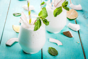 Pina-Colada-Sorbet-Ice-Cream-–-The-Best-Of-Both-Worlds-image-3-pina-colada-sorbet in glasses with fresh leaves Frosted-Fusions