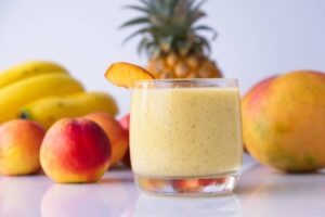 Pina-Colada-Sorbet-Ice-Cream-–-The-Best-Of-Both-Worlds-image-4 pina-colada-mango sorbet with fresh peach pineapple mango banana in background Frosted-Fusions