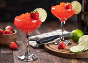 Strawberry Daiquiri Sorbet – A Boozy, Cocktail-Inspired Frozen Treat image 1 two cocktail glasses of strawberry daiquiri Frosted Fusions