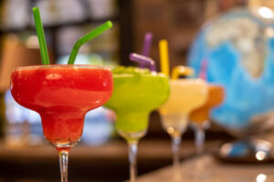Strawberry Daiquiri Sorbet – A Boozy, Cocktail-Inspired Frozen Treat image 2 three different fruit daiquiris lined up in cocktail glasses Frosted Fusions