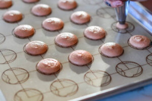 homemade-macaron-ice-cream-recipes-and-ideas-image-3 tray of macarons on macaron sheet beng piped Frosted Fusions