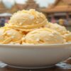 Celebrate Songkran With A Thai-Inspired Coconut & Mango Ice Cream featured image 2 637x1920w bowl of coconut and mango ice cream with fresh mango cococnut and water background Frosted Fusions