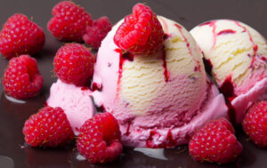 Easy-No-Churn-Easter-Ice-Creams-–-Festive-Fun-For-All-Ages-image-4-raspberry-ripple-ice-cream-with-fresh-raspberries-Frosted-Fusions