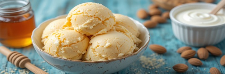 Honey, Yoghurt & Toasted Almond Ice Cream – A Naturally Sweet Scoop featured image 637x1920w bowl of honmey ice cream with a glass jar of honey dish of yoghurt and fresh almonds to the side Frosted Fusions
