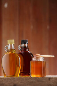 Honey, Yoghurt & Toasted Almond Ice Cream – A Naturally Sweet Scoop image 4 three bottles and jars of honey maple syrup and agave Frosted Fusions