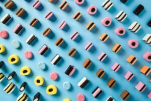 National-Liquorice-Day-–-Meets-A-Bold-Homemade-Ice-Cream-image-6-selection-of-liquorice-allsorts-lined-up-showing-all-varieties-blue-background-Frosted-Fusions