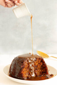 Sticky Toffee Pudding Ice Cream – A Delicious Fusion Of Flavours image 1 sticky toffee pudding with toffee sauce being poured Frosted Fusions