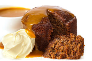 Sticky Toffee Pudding Ice Cream – A Delicious Fusion Of Flavours image 4 close up of rich sticky toffee pudding next to a scoop of ice cream Frosted Fusions