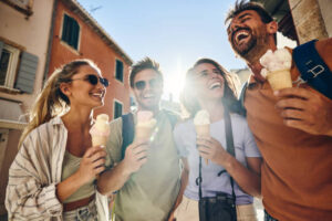 Summertime, And The Ice Cream Is Easy – It’s Ice Cream Time Image 2 group of people with ice creams in the sunshine laughing and happy Frosted Fusions