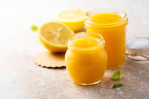 The Easter Ice Cream Egg Illusion A Fun Unexpected Easter Treat Image 7 jar of lemon curd with fresh lemons Frosted Fusions