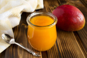 The Easter Ice Cream Egg Illusion A Fun Unexpected Easter Treat Image 8 jar of mango coulis with fresh mango Frosted Fusions