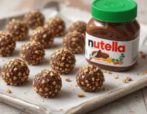 Nutellas-Gone-Vegan-–-Try-Our-Healthy-Easy-Recipes-That-Youll-Love-Image-4 tray of Vegan Nutella bites with a jar of vegan nutella to the side Frosted-Fusions