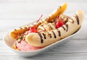 How-To-Guide To Make The Perfect Banana Split Sundae image 2 banana split in glass dessert dish showing the layers Frosted Fusions